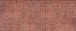 Panoramic background of wide old red and brown brick wall texture. Home or office design backdrop.