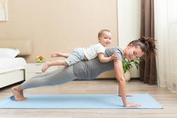 Health and fit concept. Young beautiful pregnant asian woman doing fitness exercise in the domestic room with her little kid son together. FItness materinity and motherhood