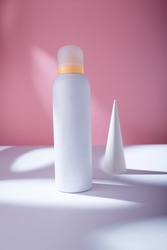 White deodorant body spray or shower foam bottle on pink background mockup template, container with no brand in harsh light