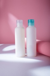 Hair conditioner and shampoo mockup bottles, white template containers on pink background, harsh light. Care cosmetics no brand