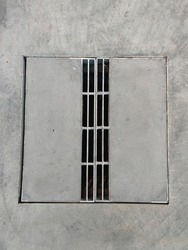 manhole cover  in the city on gray concrete road  Modern steel frame square vent.