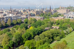 Aerial view from Scottish Edinburgh castle at Princes Street gardens and Waverley railway station. In the background Calton Hill