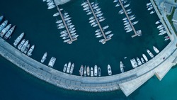 Aerial view of yachts and boat berthed in the marina and clear water. Aerial view of the Marina in Turkey. Holiday icons .
