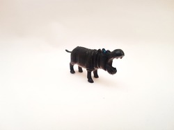 Children's toy made of solid plastic with a black hippopotamus animal character opening its mouth