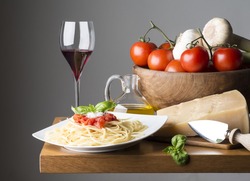 dish with spaghetti and ingredients on the wooden table