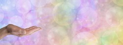 Rainbow Bubble Message Banner Template - male hand with open palm in bottom left corner against a wide multicoloured bubble bokeh background with space for text
                              