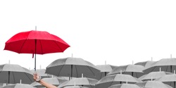 red umbrella over dark umbrellas on white background. The difference to step up to leadership in business.hand of man holding a red umbrella in raining. side view.