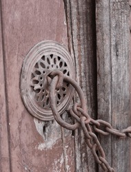Old doorknob, knocker chained door in Cumalikizik, Bursa, Turkiye. Chain, lock. Chained, locked.