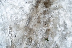 Trace of car and footstep on the snow ground pathway during frozen cold winter