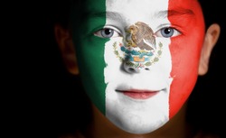Portrait of a child with a painted Mexican flag, closeup