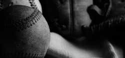 Old used baseball ball with dark grunge texture for sport nostalgia feel.