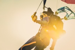 Military parachuting, skydiving sports in Thailand  ,  Kite surfer sailing in the sea at sunset ocean
