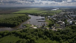 River port among green trees in a small town from a bird's eye view.