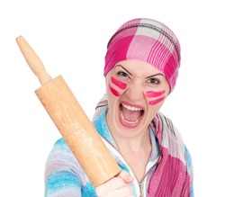 Mad housewife with rolling pin on white background