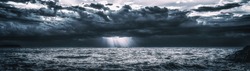 Storm Clouds Over Cold Sea Water. Stylized panoramic seascape. Dramatic sky over Lake Superior. Great Lakes view from Keweenaw County, Michigan, USA. Wide banner background with copy space.