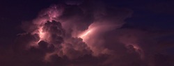 Panorama Dark cloud at  night with thunder bolt. Heavy storm bringing thunder, lightnings and rain in summer.