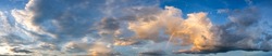 Panorama sunset sky and dark clouds.Fluffy cloud in the black sky background.Vivid sky on dark cloud before summer storm with color rainbow.
