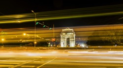 A wide angle long exposure shot of India Gate (formerly known as the All India War Memorial) with light trails of moving vehicles at Rajpath, New Delhi, India.