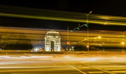 A wide angle long exposure shot of India Gate (formerly known as the All India War Memorial) with light trails of moving vehicles at Rajpath road, New Delhi, India.