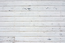 Old wall with white peeling siding