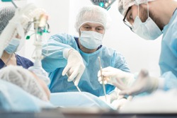 Another surgery. Surgery medical team operating in a surgery room of the hospital mature surgeon leading an operation profession professionalism occupation teamwork medical people doctors concept