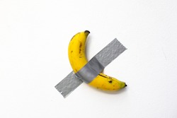duct taped banana on white wall
