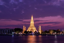 Wat Arun Ratchawararam Ratchawaramahawihan Public Landmark in Bangkok in sunset time with reflections on water Night shot.