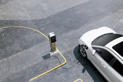 Aerial top view image of progressive green energy-powered charging station, electric vehicle at public car park with EV car concept for alternative transportation and energy infrastructure.