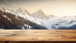 The empty wooden table top with blur background of Alpine with snow capped. Exuberant image.