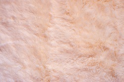 Pink shaggy blanket texture as background. Fluffy fake textile fur.