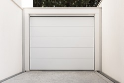 Lift gate to private yard. White wide doors between walls
