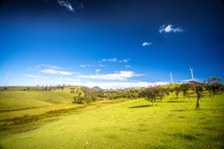 Windmills at Ambewela New Zealand farm on a beautiful sunny day in Sri Lanka