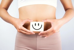Women Stomach Health. Healthy Female With Beautiful Fit Slim Body  Holding White Card With Happy Smiley Face In Hands Good Digestion Concepts. High Resolution