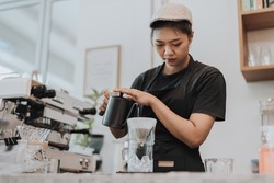 Barista making coffee by pour over in coffee shop. Close up of hands barista to making a drip coffee. Coffee shop concept