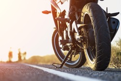 A motorcycle parking on the road right side and sunset, select focusing background.
