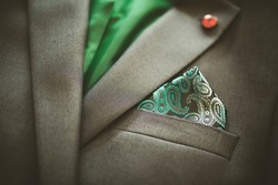 Detail of pocket square of man in gray suit.