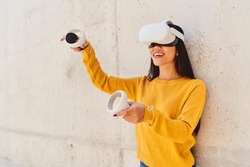 Happy asian woman using metaverse VR set