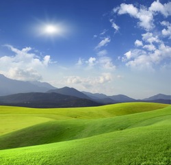 Green meadow and mountains on the horizon
