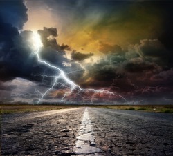 The asphalted road and thunderstorm with lightning