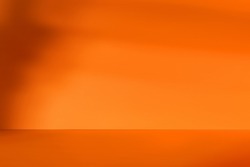 Empty orange room with deep artistic shadow. Minimalistic space concept