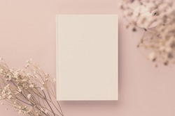 White book blank cover mockup on a beige background with dry flower, flat lay, mockup