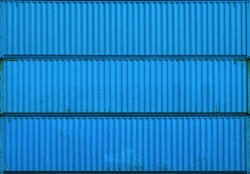 The blue blank surface texture of the sea container. Three stacked containers without labels.