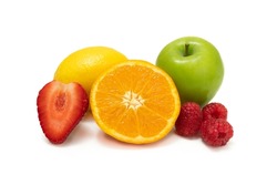 Fresh juicy fruit selection with a halved juicy orange, half red strawberry juicy green apple a lemon and rasberries on a white background