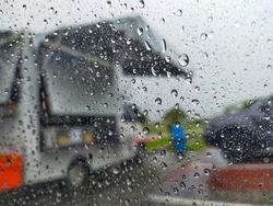 A blurry view of a food truck when it rains