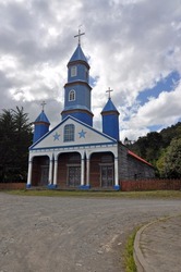 Wooden church on Chiloe Island, Chile. Chiloe Island is the largest island of the Chiloe Archipelago off the west coast of Chile, in the Pacific Ocean.