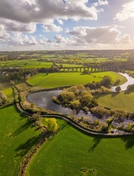 Aerial view over Arthington Viaduct and the River Wharfe on a sunny autumn day. Meandering river bends through the North Yorkshire countryside. UK