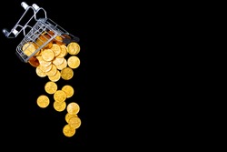Overturned little shopping cart with gold dollar euro coins on background canvas. Black friday sale concept. Seasonal autumn discount. Hot low prices. Best deal offer to buy cheap goods, clothes.