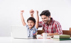 Indian kid studying online, attending school via e-learning with father
