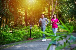 Indian asian young Couple jogging, running, exercising or stretching outdoors in park or nature