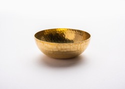 Empty Brass or golden metal bowl isolated over white background